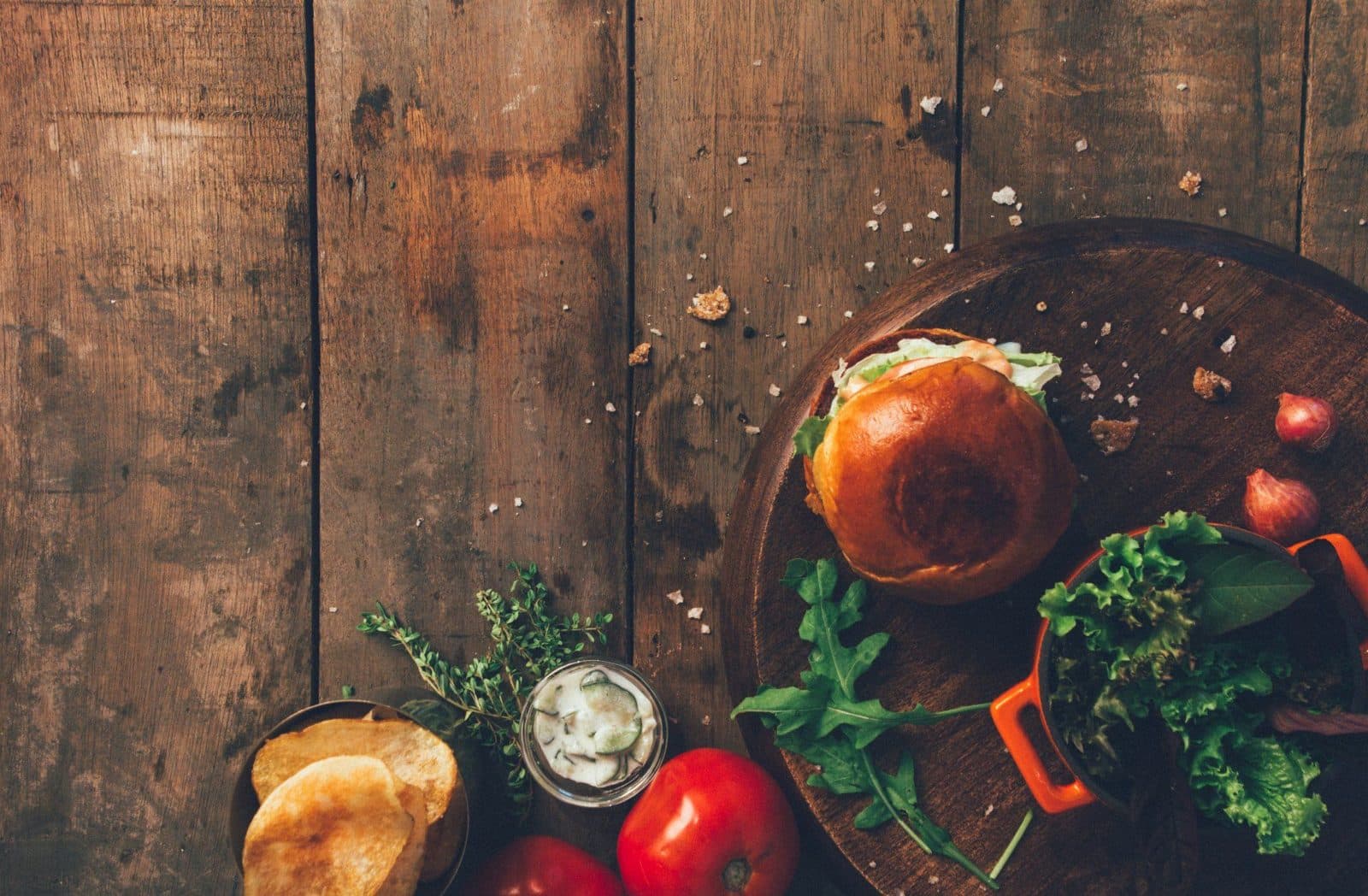 Burger with greens on a wooden board